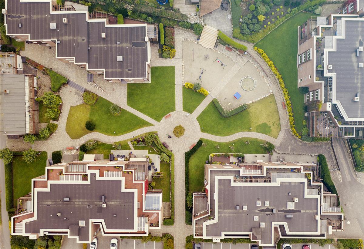 Flyfoto av boligblokker og utearealene rundt. - Klikk for stort bilde
